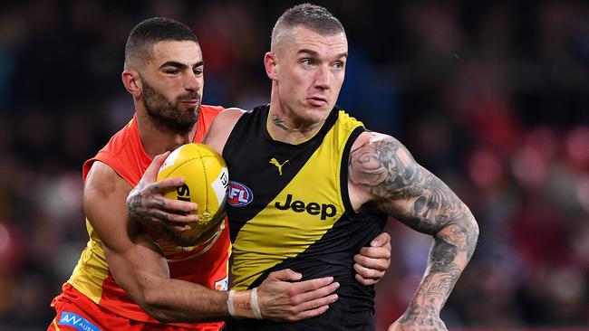 Adam Saad tries to lay a tackle on Dustin Martin. Picture: AAP