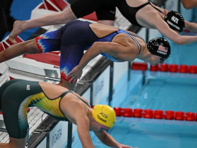 Ariarne Titmus (front) and Katie Ledecky (C) take off for the final. Picture: Oli Sscraff/AFP