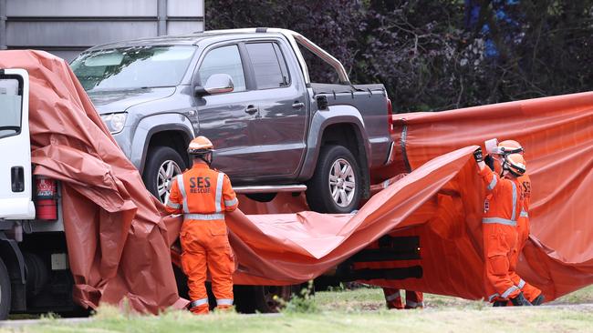 SES wrap a car believed to be involved in the shooting of a person the Eastern Freeway. Picture: David Crosling