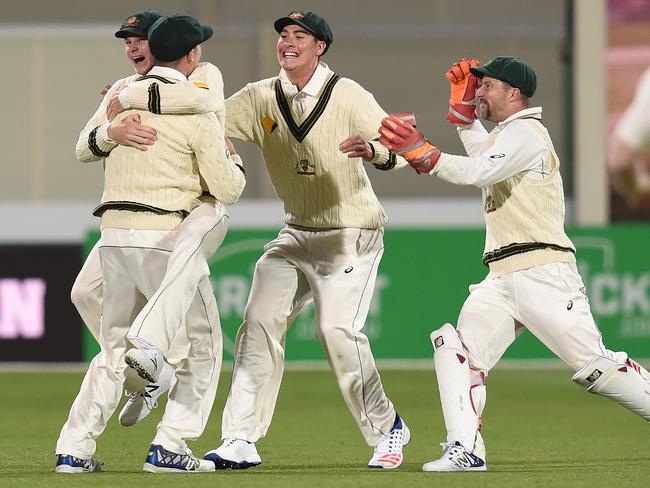 Australian captain Steve Smith reacts with Peter Handscomb after Handscomb caught out South African batsman Faf du Plessis on day three of the day-night Test match between Australia and South Africa.