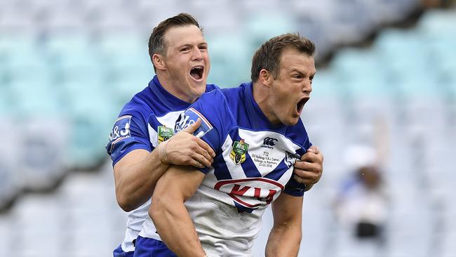 Josh Morris of the Bulldogs (right) celebrates with brother Brett (left) after scoring a try during the Round 3 NRL match between the Canterbury-Bankstown Bulldogs and the Penrith Panthers at ANZ Stadium in Sydney, Friday, March 23, 2018. (AAP Image/Dan Himbrechts) NO ARCHIVING, EDITORIAL USE ONLY