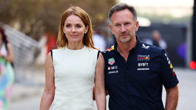 Oracle Red Bull Racing Team Principal Christian Horner and Geri Horner walk in the Paddock holding hands. (Photo by Mark Thompson/Getty Images)