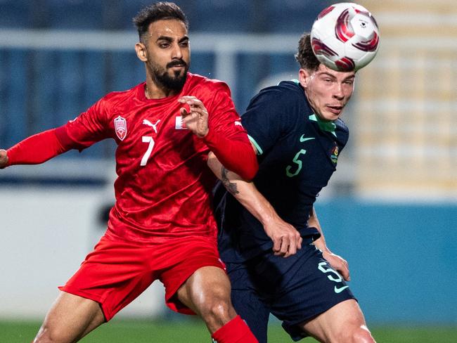 ABU DHABI, UNITED ARAB EMIRATES - JANUARY 6: Bahrain's Ali Madan (L) fights for the ball with Australia's Jordan Jacob Bos in the international friendly on January 6, 2024 in Abu Dhabi, United Arab Emirates. (Photo by Martin Dokoupil/Getty Images)