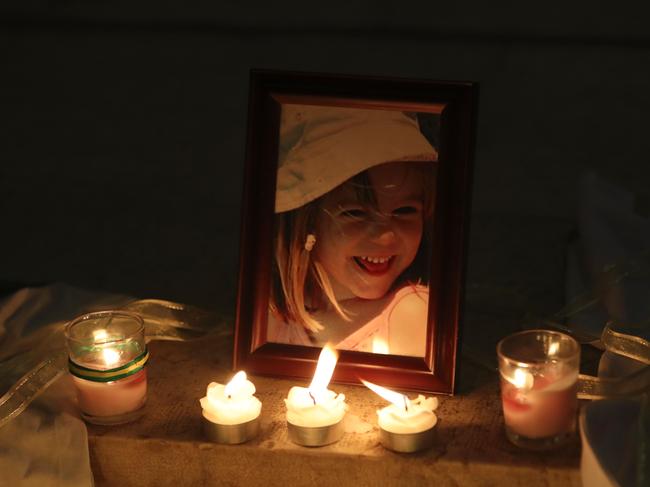 Candles light a photograph of Maddie McCann inside a church on the 10th anniversary of her disappearance. Picture: AFP