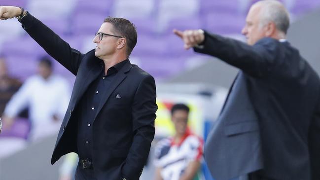 Jordan's head coach Vital Borkelmas, centre, and Australia's head coach Graham Arnold, right, give instructions from the side line during the AFC Asian Cup group B soccer match between Australia and Jordan at Hazza bin Zayed stadium in Al Ain, United Arab Emirates, Sunday, Jan. 6, 2019. (AP Photo/Hassan Ammar)