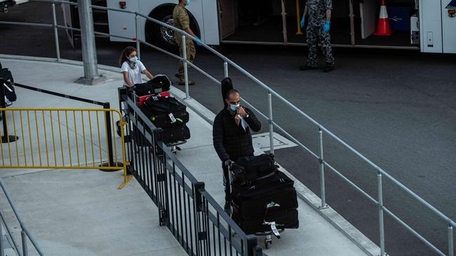 Airline crew and passengers at Sydney International airport before being transferred to hotel quarantine in Sydney. Picture: NCA NewsWire / Flavio Brancaleone