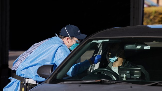 Testing is carried out at the new 24-hour drive-through COVID-19 testing clinic at the Mountie's Club carpark in Mount Prichard, Sydney, on Thursday. Photo: Brook Mitchell/Getty Images