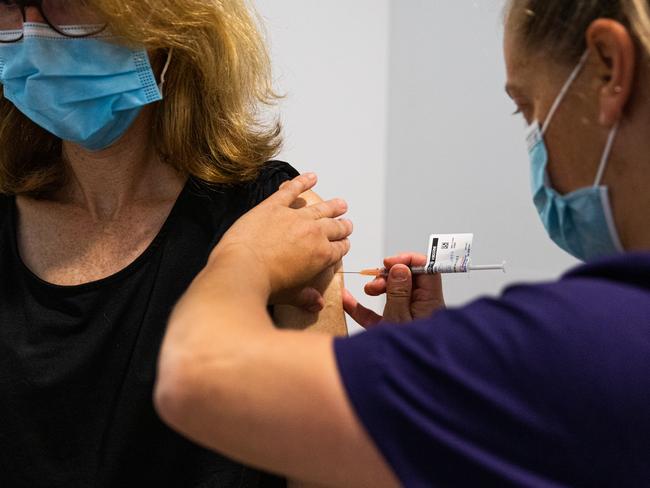 MELBOURNE, AUSTRALIA - MARCH 17: A nurse administers the AstraZeneca COVID-19 vaccine to a patient at the Austin Hospital on March 17, 2021 in Melbourne, Australia.  An online system has opened for phase 1B of the Australian COVID-19 vaccination program which includes people over aged 70, frontline workers, and individuals with certain medical conditions. Over 1000 general practitioners are participating in the vaccination program. (Photo by Asanka Ratnayake/Getty Images)