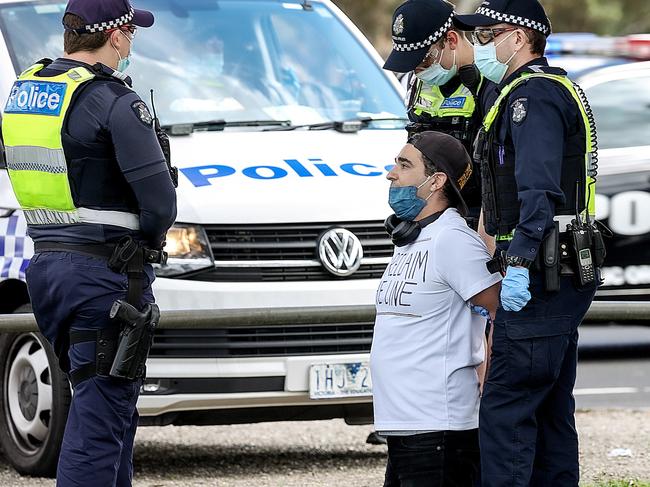 A protester is held by police. Picture: Ian Currie