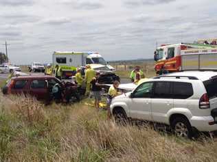 Emergency crews attend the scene of a two-car crash on the Warrego Highway, Gowrie Mountain. Picture: Stuart Cumming