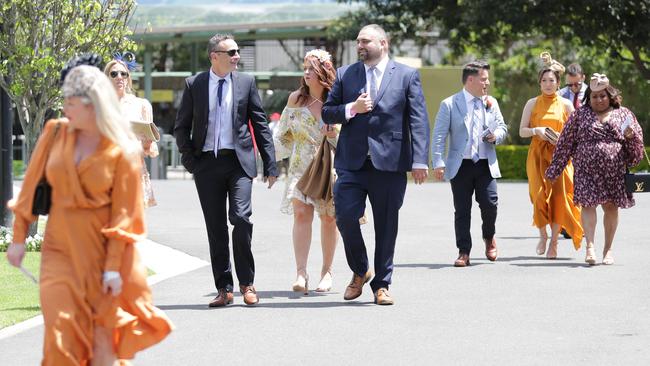 Groups flocked into Randwick Racecourse in smaller than usual numbers, with groups seen distancing themselves from others. Picture: NCA NewsWire/Christian Gilles