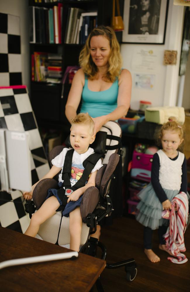 Roki Mills has been given an eye gaze computer so he can learn how to communicate using his eyes to choose words. Pictured with mum Ina and Ruby, 5. Photo: twolittlebirdsphotography.com.au.