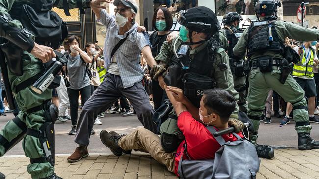 Pro-democracy supporters scuffle with riot police at a rally in Hong Kong. Picture: Getty Images