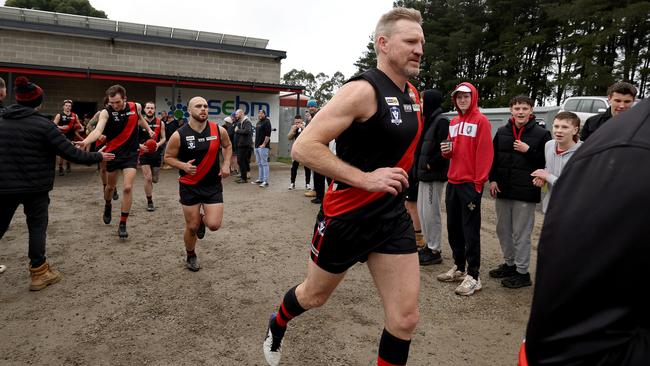 Nathan Buckley runs out with Nilma Darnum. Photo by Jonathan DiMaggio/Getty Images for Bursty PR