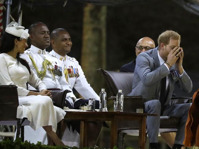 Harry sampled the traditional Fijian drink as Meghan looked on. Picture: AP/Kirsty Wigglesworth