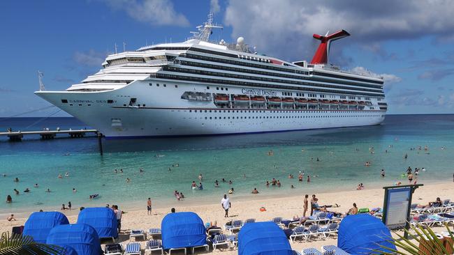 In this photo released by Carnival Corp. & plc, passengers aboard the Carnival Destiny enjoy the beach at the Grand Turk Cruise Terminal Wednesday, Oct. 8, 2008, in Grand Turk, Turks and Caicos. The arrival of Carnival Destiny marked the first time a cruise ship has called at Grand Turk since prior to Hurricane Ike's devastating blow to the island a month ago. Carnival imported temporary housing, food, supplies, foliage and supplemental labor to effect repairs to the facility to reopen it for cruise passengers. (AP Photo/Carnival Corp. & plc, Andy Newman)