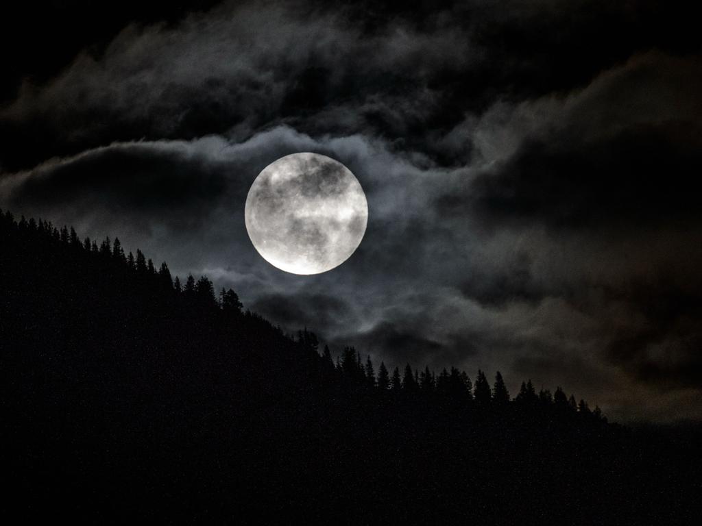 The full moon can be seen over a forest near Garmisch-Partenkirchen, southern Germany on January 31, 2018. Picture: AFP