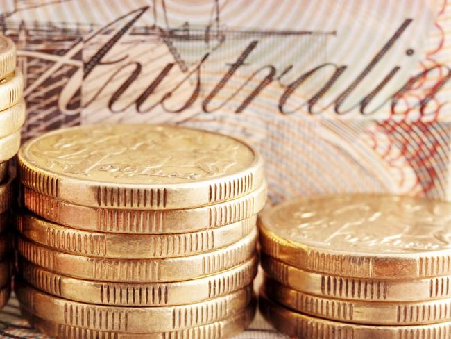 Australian money - coins, cash generic. Stacks of one dollar coins, with twenty dollar note behind.