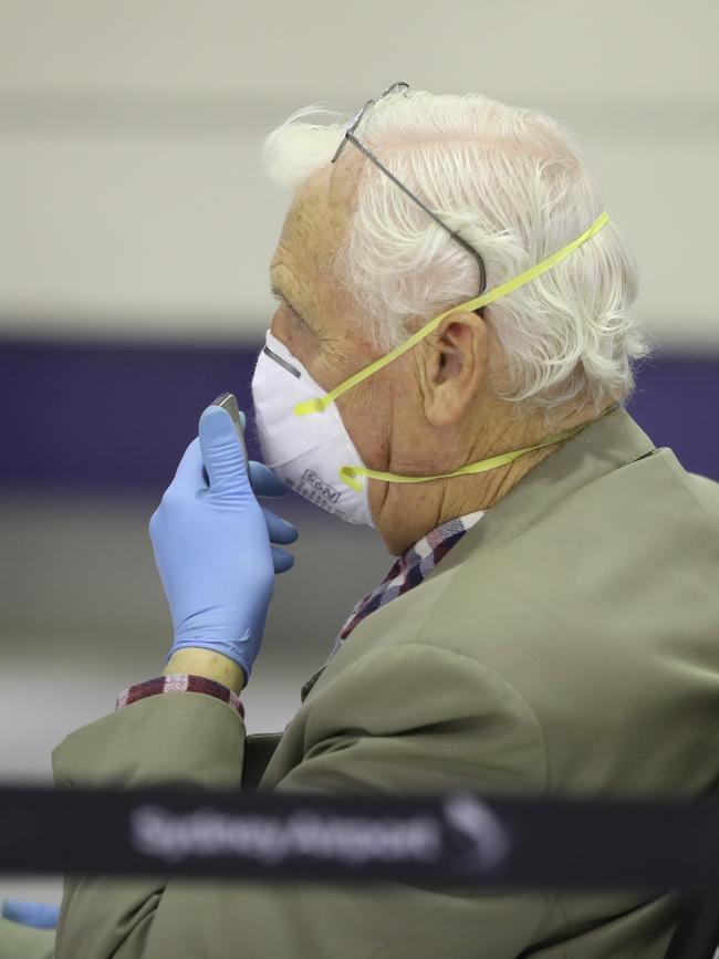 Many older passengers wore gloves and masks.