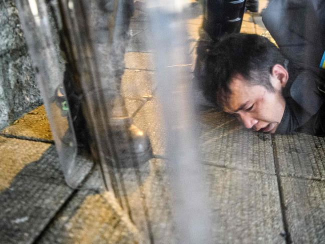 Police arrest a man during protests in Tsim Sha Tsui. Picture: AFP)