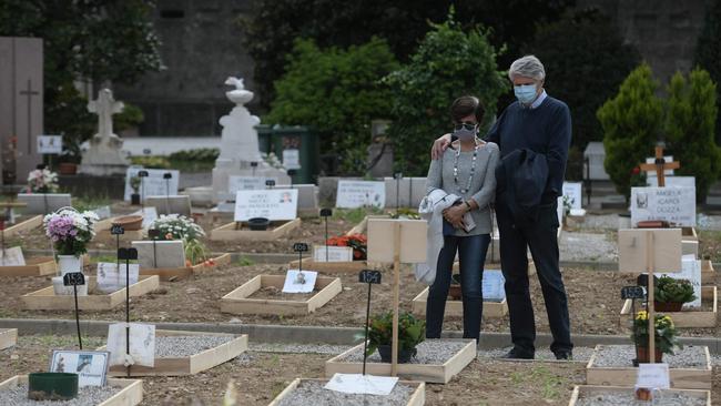 People visit the grave of a relative at the Monumental Cemetery of Bergamo, Lombardy. Picture: AFP