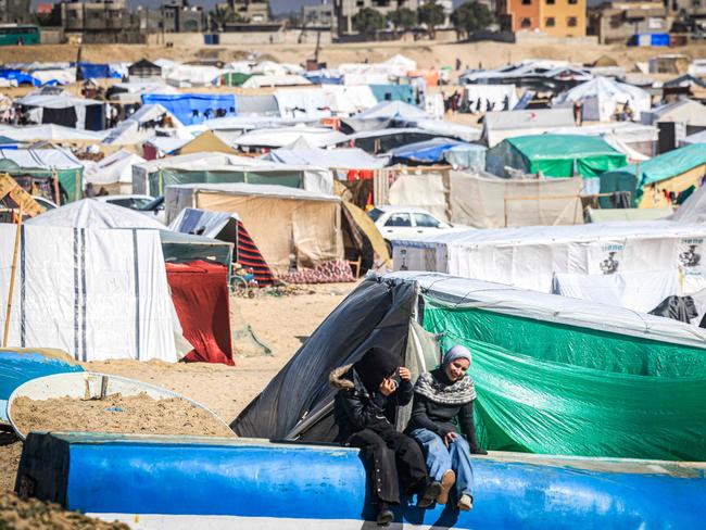 Children sit near tents at a makeshift shelter for Palestinians who fled to Rafah in the southern Gaza Strip. Picture: AFP