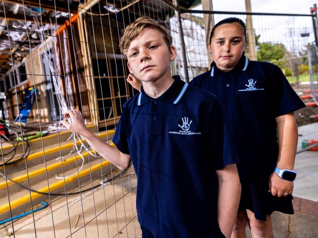 Lucas and Zara in front of ongoing school refurbishment work at Mildura West Primary School. Picture: Brandan McGlynn