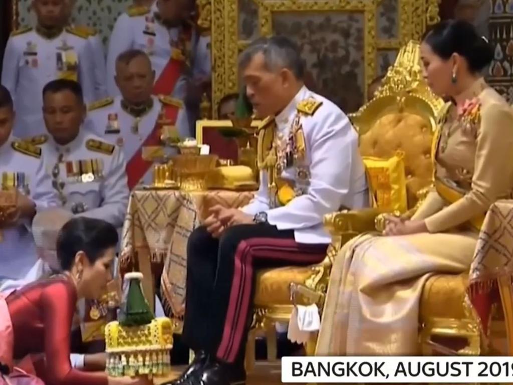 There were three of us in this marriage: Sineenat kneels before King Maha Vajiralongkorn and Queen Suthida after being named royal noble consort in August 2019. Picture: Sky News