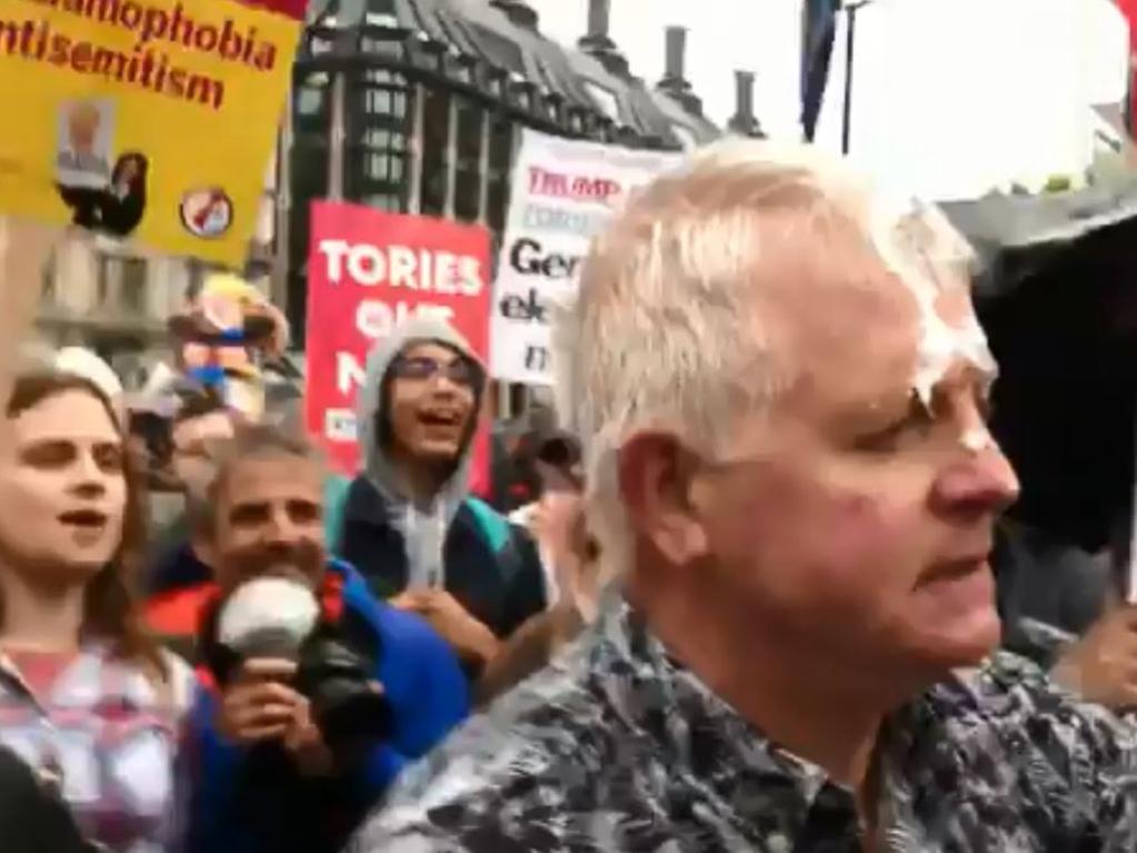 Protesters laugh as a Donald Trump supporter is hit with a milkshake and a fight breaks out.