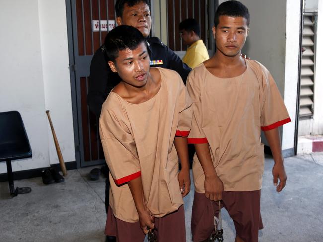 Myanmar migrant workers Zaw Lin (R) and Wai Phyo (L) are escorted by a Thai police officer after they were sentenced to death at the Samui Provincial Court, on Koh Samui Island. Picture: Rungroj Yongrit