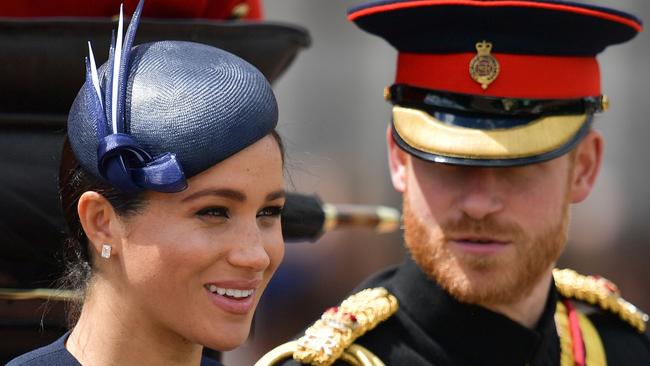 Britain's Meghan, Duchess of Sussex (L) and Britain's Prince Harry, Duke of Sussex (R) return to Buckingham Palace after the Queen's Birthday Parade, 'Trooping the Colour', in London on June 8, 2019. - The ceremony of Trooping the Colour is believed to have first been performed during the reign of King Charles II. Since 1748, the Trooping of the Colour has marked the official birthday of the British Sovereign. Over 1400 parading soldiers, almost 300 horses and 400 musicians take part in the event. (Photo by Daniel LEAL-OLIVAS / AFP)