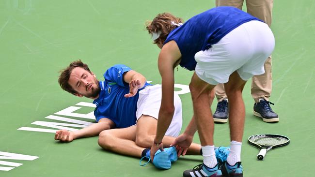 Daniil Medvedev of Russia reacts as Alexander Zverev of Germany touches his foot after Medvedev fell during second set action in their fourth round tennis match at the 2023 ATP Indian Wells Masters on March 14, 2023 in Indian Wells, California. (Photo by Frederic J. BROWN / AFP)