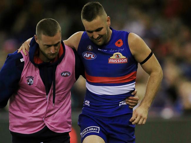 Matt Suckling limps from the ground after injuring his knee. Picture: Wayne Ludbey