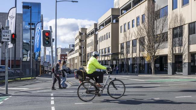 Cyclist on the intersection of Collins and Barrack streets. New bike lanes are set to be installed on Collins St as part of a two-year Hobart City Council trial. Picture: Caroline Tan