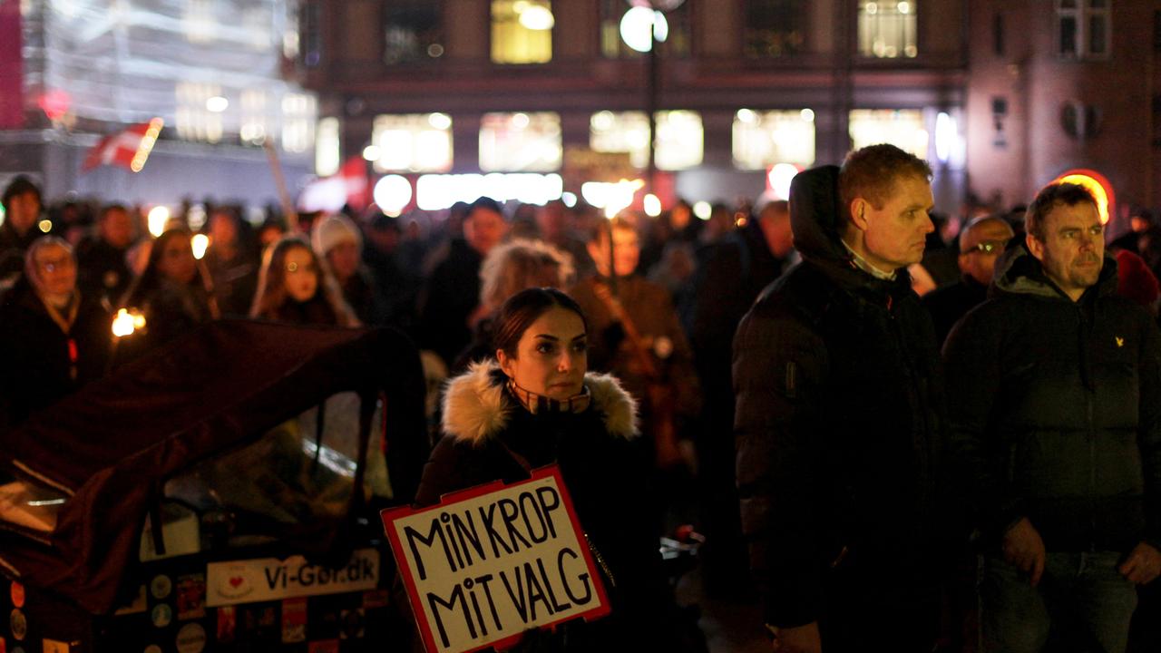 A demonstrator holds a placard reading 'My body, my choice' during a rally to protest against Covid-19 restrictions in Denmark. Picture: Thibault Savary / AFP