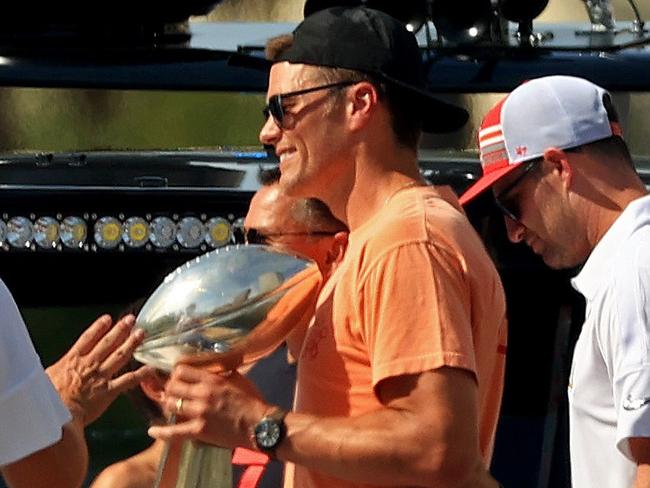 TAMPA, FLORIDA - FEBRUARY 10: Tom Brady #12 of the Tampa Bay Buccaneers celebrates their Super Bowl LV victory with the Vince Lombardi trophy during a boat parade through the city on February 10, 2021 in Tampa, Florida.   Mike Ehrmann/Getty Images/AFP == FOR NEWSPAPERS, INTERNET, TELCOS & TELEVISION USE ONLY ==