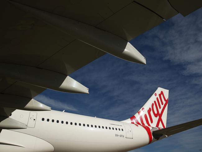 The Virgin Australia Holdings Ltd. logo is displayed on the tail of an Airbus SAS A330 aircraft at Sydney Airport in Sydney, Australia, on Monday, Aug. 17, 2015. Virgin Australia launched its new business-class suites for its A330 fleet. Photographer: Brendon Thorne/Bloomberg