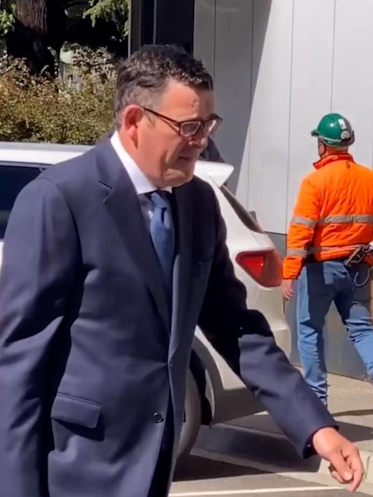 Daniel Andrews walking from his car to Parliament without a mask.