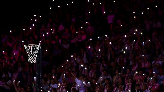 Fans hold torches as a power cut affects parts of the stadium during the match between Adelaide Thunderbirds and NSW Swifts at on March 25, 2023 in Adelaide. (Photo by Graham Denholm/Getty Images)