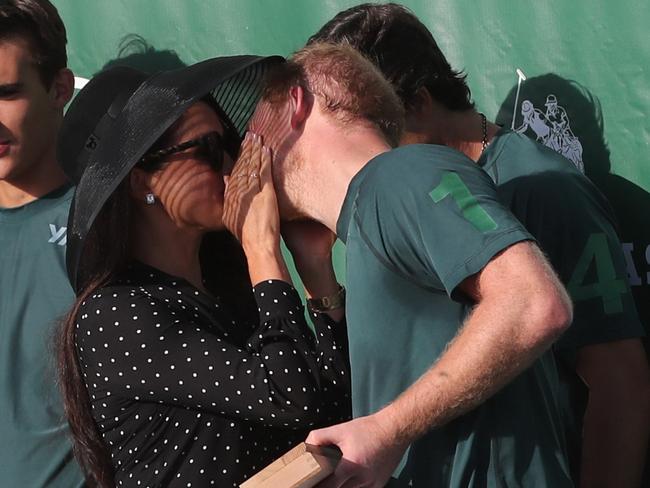 Meghan Markle presented the trophy to the team and kisses each teammate on both cheeks before French kissing Harry and then wiping the lipstick off his face. Picture: Backgrid.