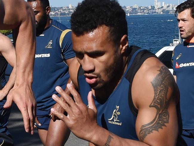 Wallabies players (lt-rt) Bernard Foley, Matt Toomua, Will Genia and Quade Cooper doing hill sprints during their final training session at Little Manly Beach in Sydney, Friday, Aug. 28, 2015. The Wallabies fly out tomorrow for the Rugby World Cup in England. (AAP Image/Dean Lewins) NO ARCHIVING