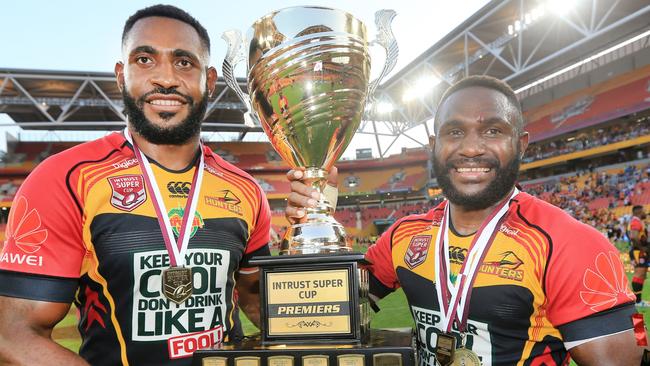 PNG Hunters players hold aloft the Queensland Cup trophy.