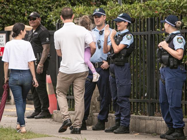 Police greet parents and children at the college.