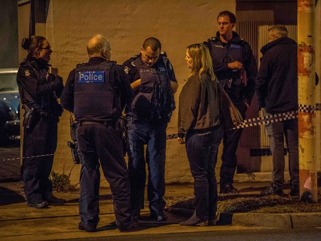 A woman, believed to be a relative of the deceased, speaks to police. Picture: Jake Nowakowski