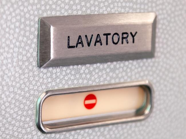 Vacant red sign, occupied symbol on an airplane lavatory door. Raised, brushed metal lavatory sign, recessed plastic vacant sign. Toilet room, wc, water closet on airplane board. Picture: istock