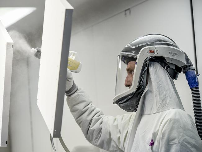 Furniture Company Retooling.A worker sprays In the powder coating booth.UCI, an Australian business that provides fit-outs for offices is turning its production to make safety screens and anti-microbial benches for cafes and doctors in a bid to ensure the continued operation of the company in a time when few companies will be fitting out new offices. They're using a special powder coat via to spray benchtops with a material that kills bacteria and other microbes.Monday 4 May 2020 Pic Roy Van Der Vegt