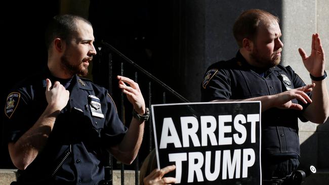 Police watch over anti-Trump demonstrators outside the Manhattan District Attorney's office in New York. Picture: AFP.