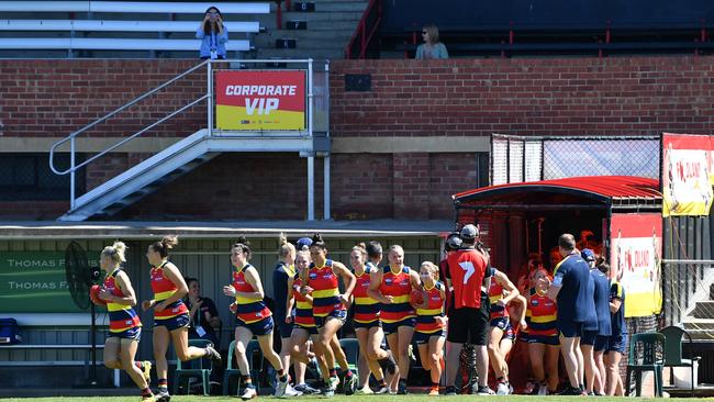 Crows players run onto the field during the Round 6 AFLW match between the Adelaide Crows and GWS Giants at Richmond Oval in Adelaide, Sunday, March 15, 2020. (AAP Image/David Mariuz) NO ARCHIVING, EDITORIAL USE ONLY