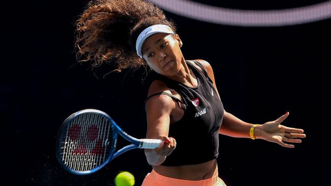 Defending champion Naomi Osaka warms up ahead of her Australian Open title defence.