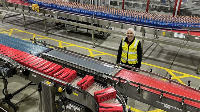 Production manager Charles Nassif watches Coca-Cola roll off the line.